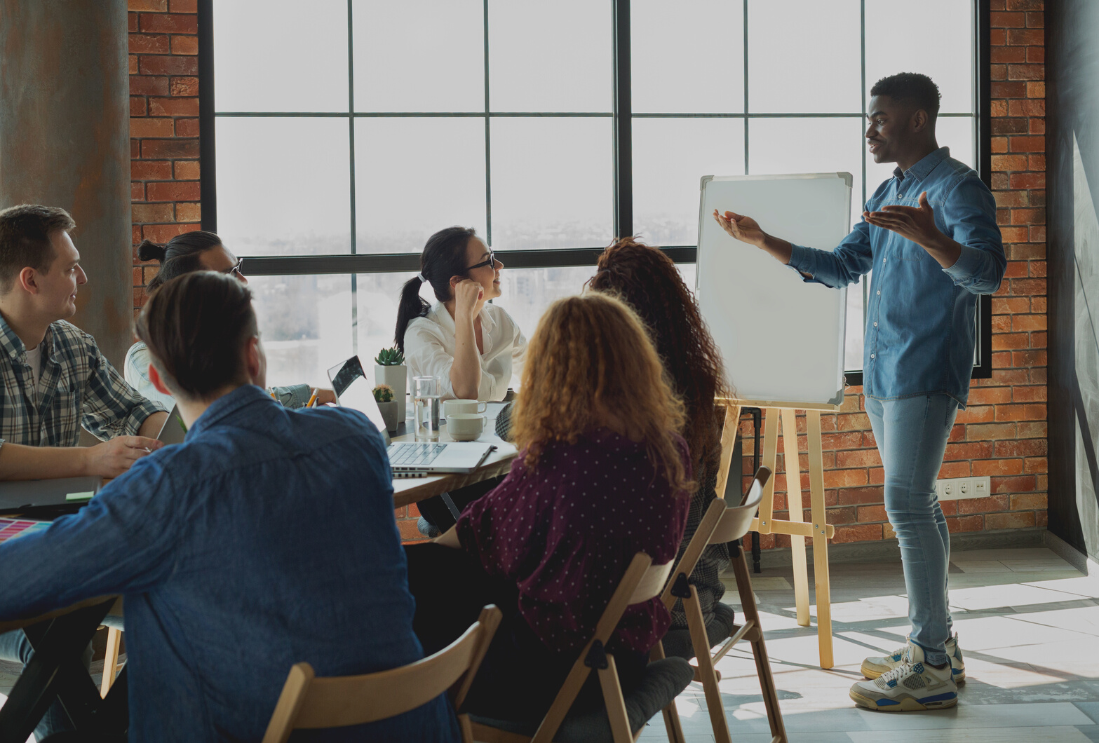 African-american leader lecturing his employees in office